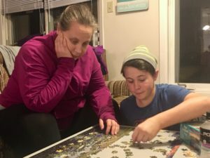 Gina and Taylor on a puzzle at Mont Ste. Marie cottage.